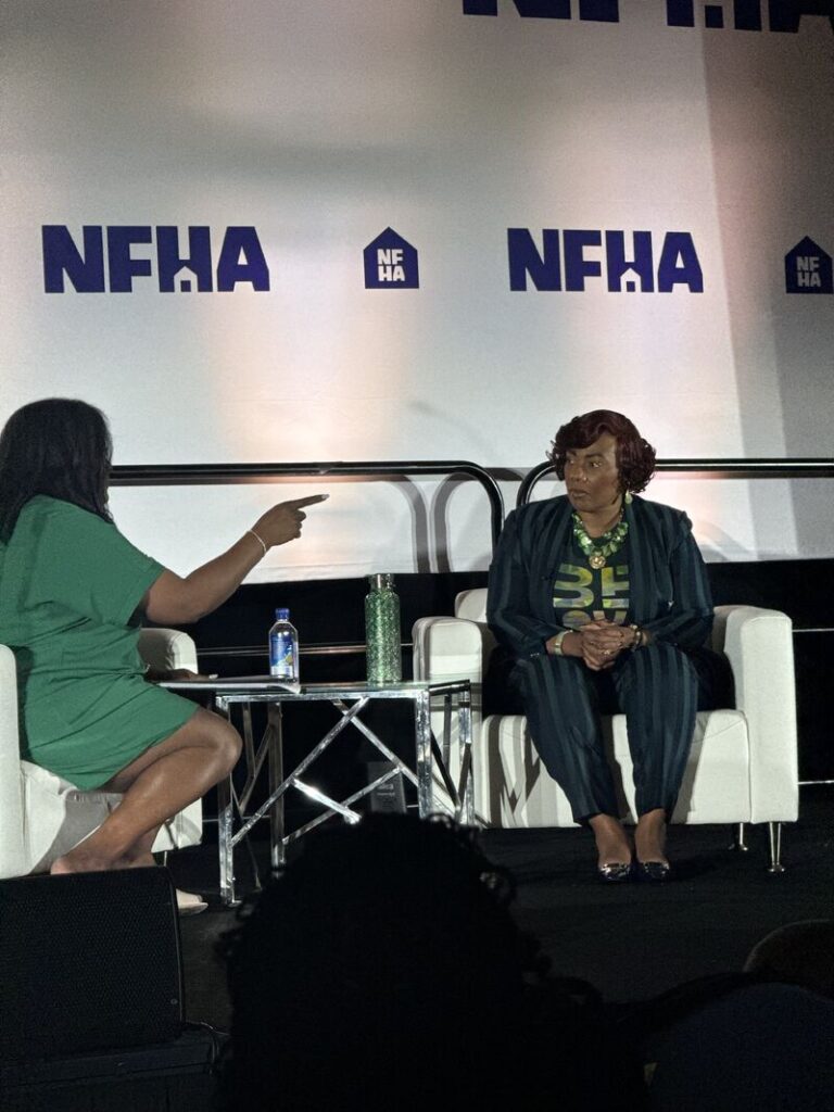 Two women conversing onstage at NFHA event