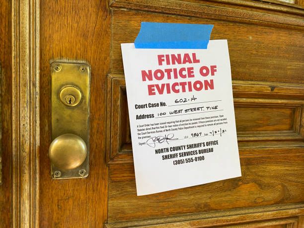 Final eviction notice pinned on wooden door