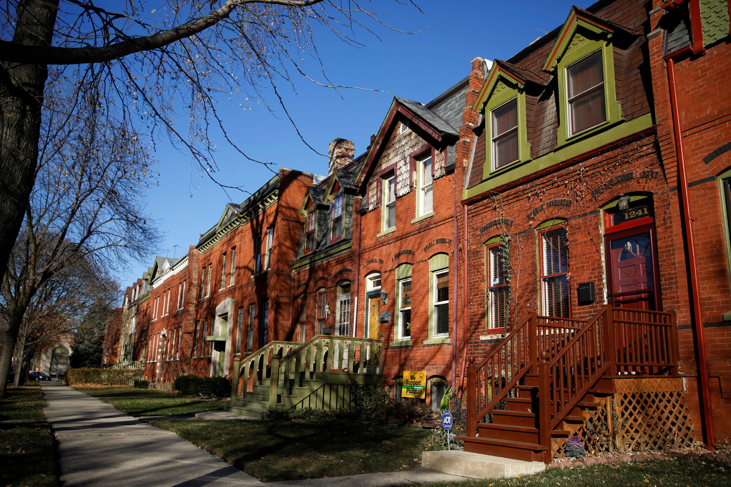 Historic brick houses on sunny residential street