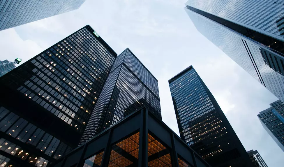 Low-angle view of modern skyscrapers at dusk