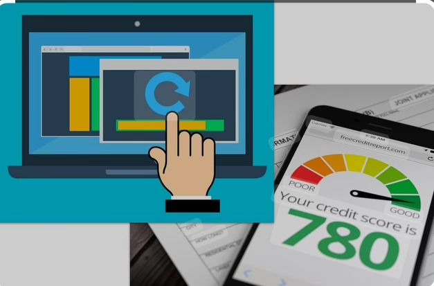 Laptop displaying graphs and smartphone showing credit score